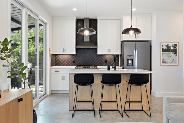 909 Mansell Ave Unit 2, Austin, TX 78702 - kitchen featuring stainless steel appliances, finished concrete floors, decorative backsplash, light countertops, and white cabinetry