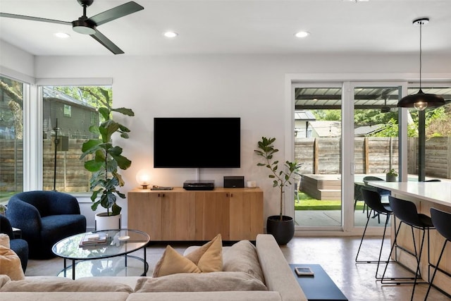 909 Mansell Ave Unit 2, Austin, TX 78702 - living room with healthy amount of natural light, a ceiling fan, recessed lighting, and finished concrete flooring