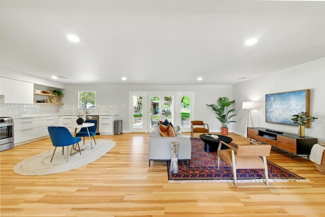living area with recessed lighting and light wood-style floors