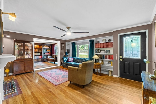 2621 W 45th St, Austin, TX 78731 - living room with wood finished floors, crown molding, and ceiling fan