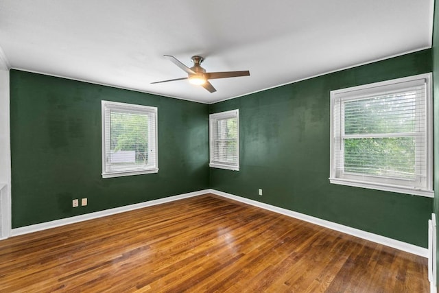 2621 W 45th St, Austin, TX 78731 - unfurnished room with wood finished floors, a ceiling fan, and baseboards