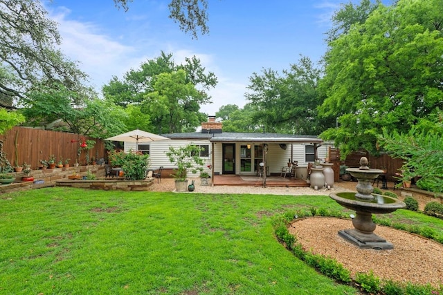 2621 W 45th St, Austin, TX 78731 - back of property featuring a garden, a chimney, and a patio