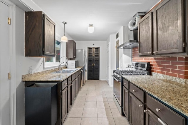 2621 W 45th St, Austin, TX 78731 - kitchen featuring appliances with stainless steel finishes, a sink, decorative backsplash, and dark brown cabinetry