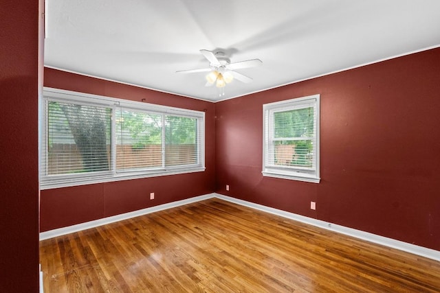 2621 W 45th St, Austin, TX 78731 - spare room with healthy amount of natural light, wood finished floors, ceiling fan, and baseboards