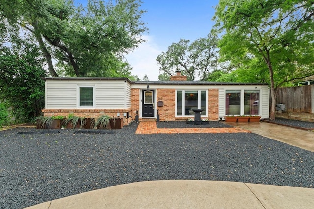 2621 W 45th St, Austin, TX 78731 - view of front facade featuring brick siding and a chimney