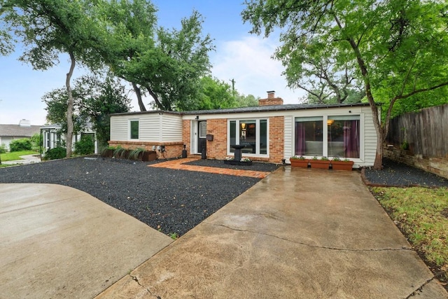 2621 W 45th St, Austin, TX 78731 - view of front of house featuring brick siding and a chimney