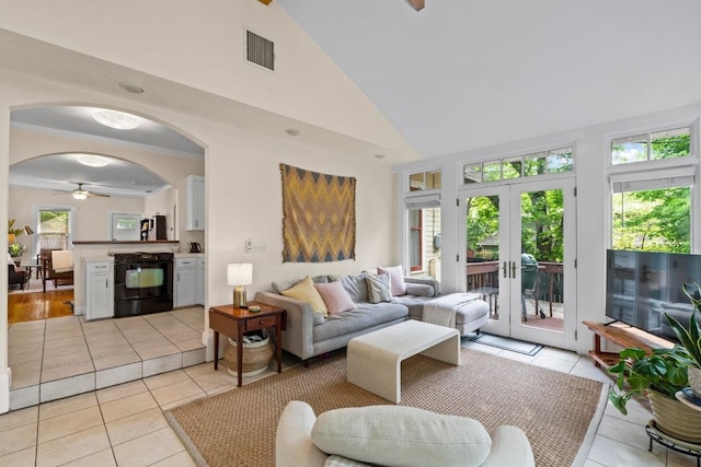 605 E 43rd St, Austin, TX 78751 - living room featuring light tile patterned flooring, arched walkways, ceiling fan, french doors, and high vaulted ceiling