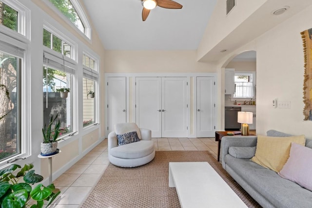 605 E 43rd St, Austin, TX 78751 - living area with light tile patterned floors, high vaulted ceiling, arched walkways, and ceiling fan