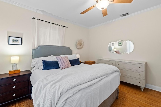 605 E 43rd St, Austin, TX 78751 - bedroom featuring ornamental molding, wood finished floors, and a ceiling fan