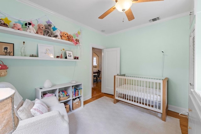 605 E 43rd St, Austin, TX 78751 - bedroom with crown molding, wood finished floors, and a ceiling fan