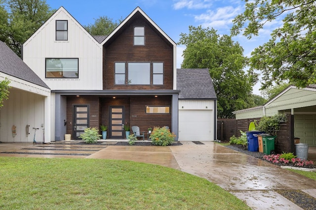 1310 Choquette Dr Unit B, Austin, TX 78757 - view of front of property featuring driveway, a shingled roof, a garage, a front lawn, and board and batten siding