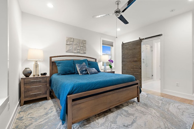 1310 Choquette Dr Unit B, Austin, TX 78757 - bedroom with a barn door, baseboards, a ceiling fan, wood finished floors, and recessed lighting