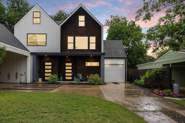 1310 Choquette Dr Unit B, Austin, TX 78757 - view of front of property featuring concrete driveway, roof with shingles, a front lawn, board and batten siding, and a garage