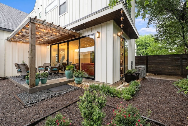 1310 Choquette Dr Unit B, Austin, TX 78757 - back of property featuring board and batten siding, a pergola, a fenced backyard, a patio, and central AC