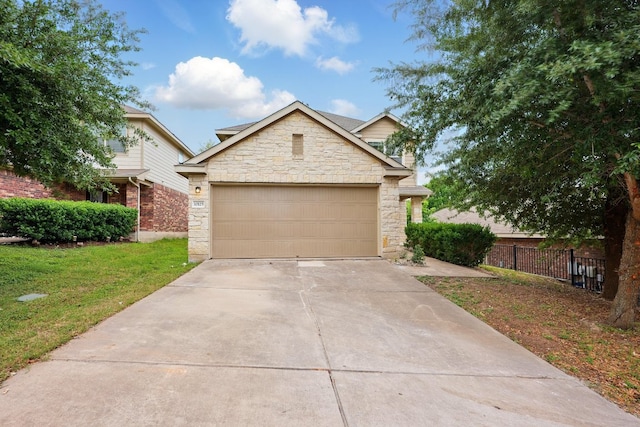 view of front of house with stone siding, driveway, and an attached garage