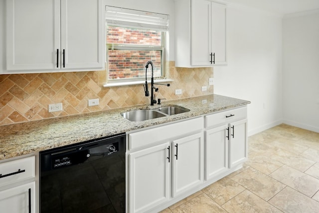 kitchen featuring black dishwasher, a sink, tasteful backsplash, light stone counters, and white cabinetry