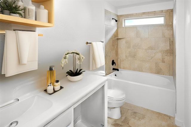 full bath featuring toilet, bathing tub / shower combination, vanity, and stone finish flooring