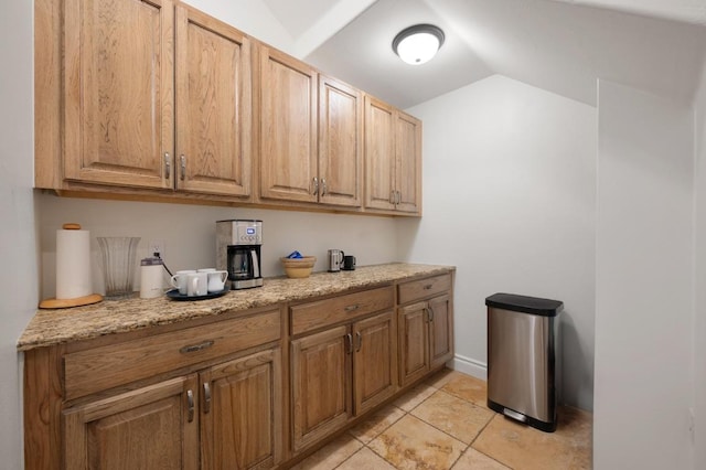 4105 Michael Neill Dr, Austin, TX 78730 - kitchen with vaulted ceiling, light tile patterned flooring, and light stone counters