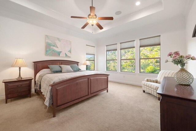 bedroom featuring a raised ceiling, light colored carpet, baseboards, a ceiling fan, and recessed lighting