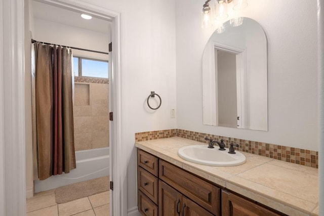 bathroom with vanity, decorative backsplash, tile patterned flooring, and shower / tub combo