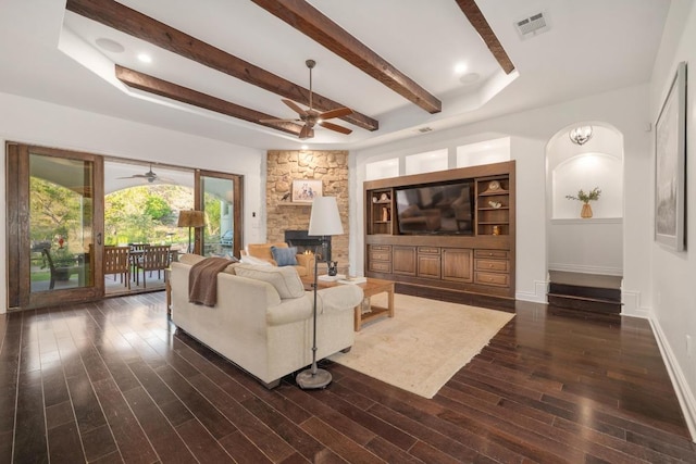 living area with ceiling fan, dark wood-style flooring, beam ceiling, and baseboards