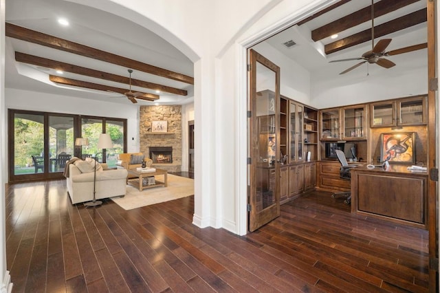 office space with a ceiling fan, beam ceiling, arched walkways, and dark wood-type flooring