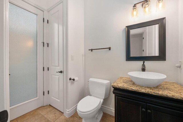 4105 Michael Neill Dr, Austin, TX 78730 - bathroom with vanity, toilet, tile patterned floors, and baseboards