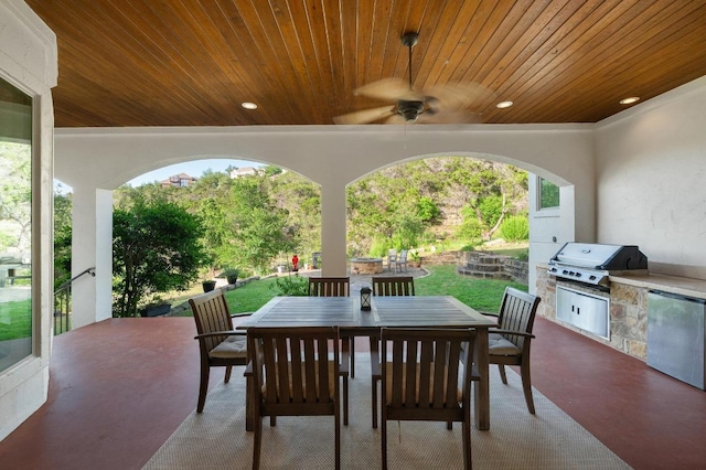 view of patio featuring area for grilling, outdoor dining area, grilling area, and ceiling fan