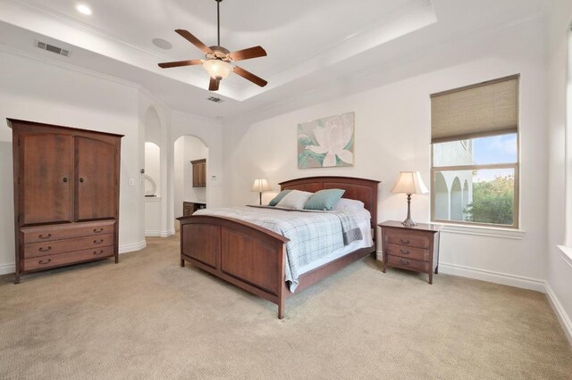 4105 Michael Neill Dr, Austin, TX 78730 - bedroom with a raised ceiling, light carpet, baseboards, arched walkways, and a ceiling fan