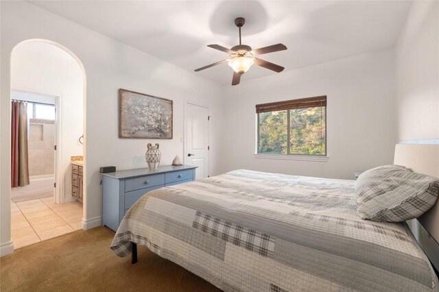 4105 Michael Neill Dr, Austin, TX 78730 - bedroom featuring light colored carpet, arched walkways, a ceiling fan, baseboards, and ensuite bathroom