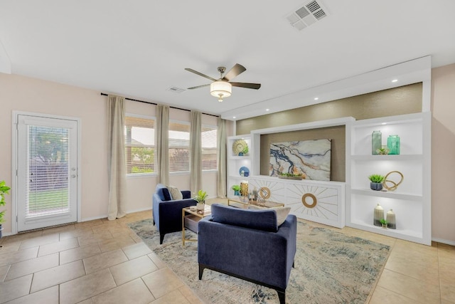 3624 Anchor Bay Dr, Pflugerville, TX 78660 - living room featuring built in shelves, a ceiling fan, tile patterned floors, and baseboards