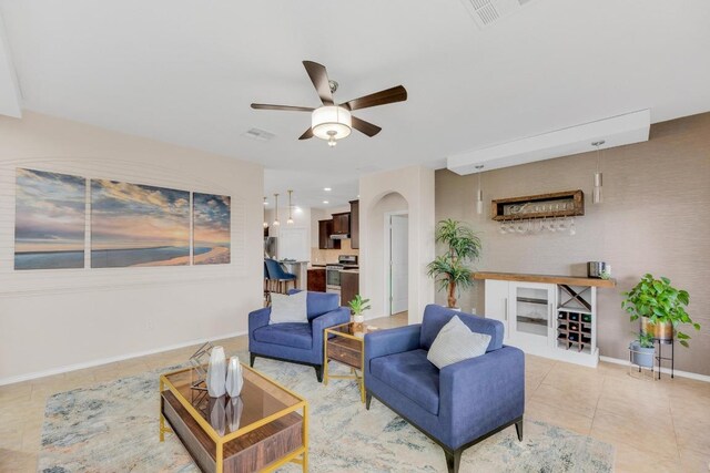 3624 Anchor Bay Dr, Pflugerville, TX 78660 - living area featuring a ceiling fan, light tile patterned floors, arched walkways, and baseboards