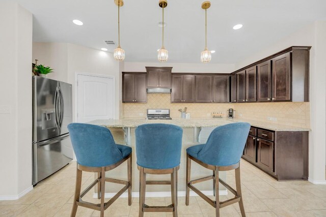 3624 Anchor Bay Dr, Pflugerville, TX 78660 - kitchen featuring stainless steel refrigerator with ice dispenser, under cabinet range hood, range, dark brown cabinetry, and recessed lighting