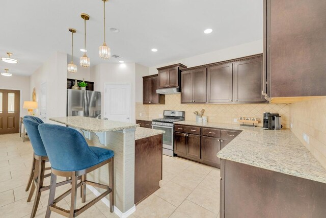 3624 Anchor Bay Dr, Pflugerville, TX 78660 - kitchen with appliances with stainless steel finishes, dark brown cabinetry, light tile patterned floors, backsplash, and recessed lighting