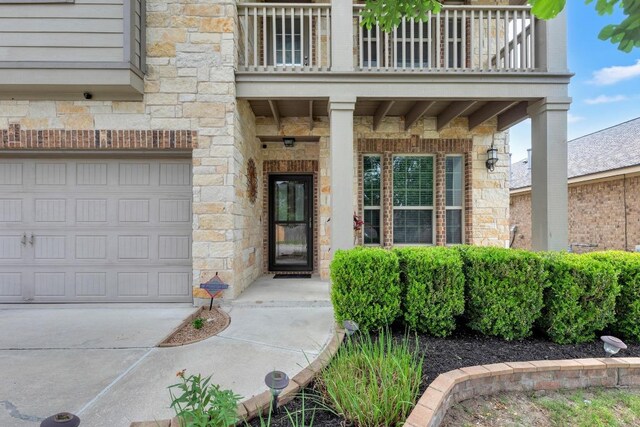 3624 Anchor Bay Dr, Pflugerville, TX 78660 - entrance to property featuring a balcony, driveway, a garage, and stone siding