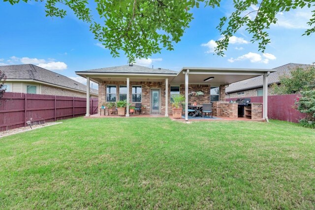 3624 Anchor Bay Dr, Pflugerville, TX 78660 - back of property featuring a patio, brick siding, and an outdoor kitchen