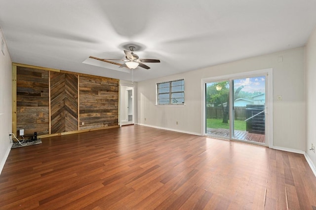 7004 Priscilla Dr, Austin, TX 78752 - unfurnished room with wood walls, ceiling fan, wood finished floors, and baseboards