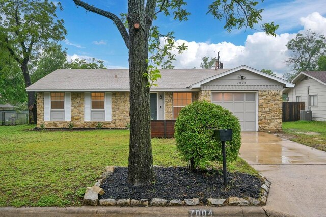 7004 Priscilla Dr, Austin, TX 78752 - ranch-style house with stone siding, concrete driveway, a garage, and cooling unit