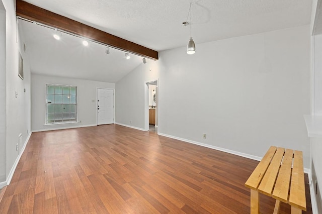 7004 Priscilla Dr, Austin, TX 78752 - unfurnished living room featuring wood finished floors, track lighting, baseboards, and a textured ceiling