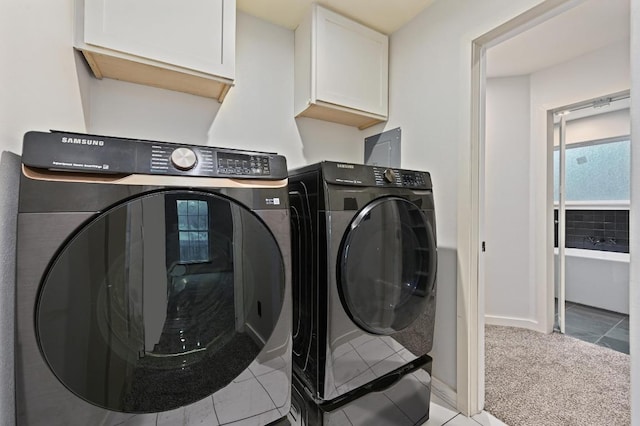 7004 Priscilla Dr, Austin, TX 78752 - clothes washing area featuring cabinet space, washer and clothes dryer, light tile patterned floors, baseboards, and light carpet