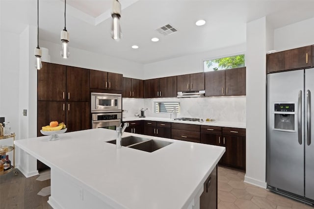 1500 Summit St Unit 5, Austin, TX 78741 - kitchen with appliances with stainless steel finishes, a sink, dark brown cabinetry, light countertops, and tasteful backsplash