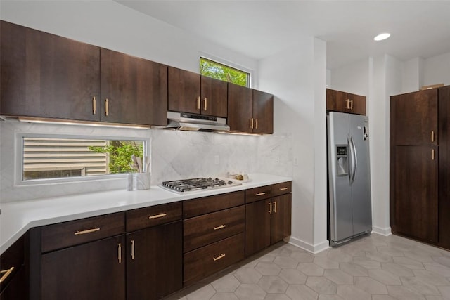 1500 Summit St Unit 5, Austin, TX 78741 - kitchen featuring stainless steel appliances, under cabinet range hood, decorative backsplash, and light countertops