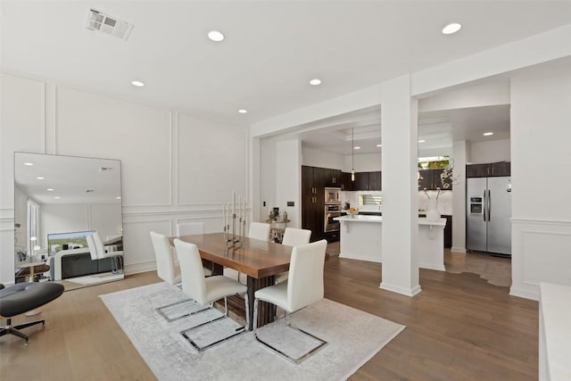 1500 Summit St Unit 5, Austin, TX 78741 - dining room with a decorative wall, wood finished floors, recessed lighting, and healthy amount of natural light