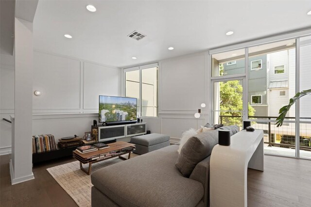 1500 Summit St Unit 5, Austin, TX 78741 - living room with a decorative wall, wood finished floors, and recessed lighting