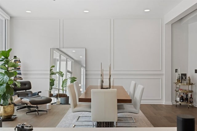 1500 Summit St Unit 5, Austin, TX 78741 - dining area featuring wood finished floors, a decorative wall, and recessed lighting