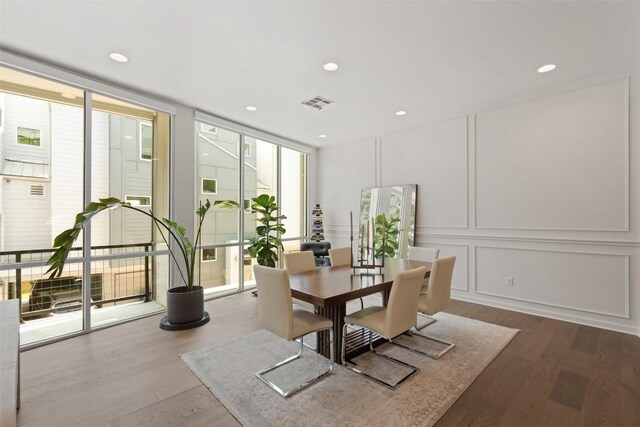 1500 Summit St Unit 5, Austin, TX 78741 - dining space featuring floor to ceiling windows, dark wood-type flooring, a decorative wall, and recessed lighting