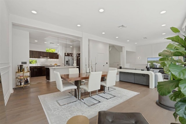 1500 Summit St Unit 5, Austin, TX 78741 - dining area featuring light wood-type flooring and recessed lighting