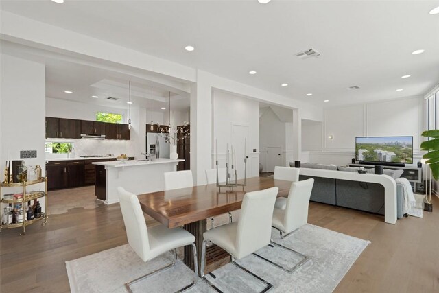 1500 Summit St Unit 5, Austin, TX 78741 - dining area featuring light wood-style floors and recessed lighting