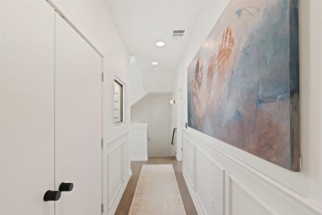 1500 Summit St Unit 5, Austin, TX 78741 - hall with a decorative wall, wood finished floors, wainscoting, and recessed lighting