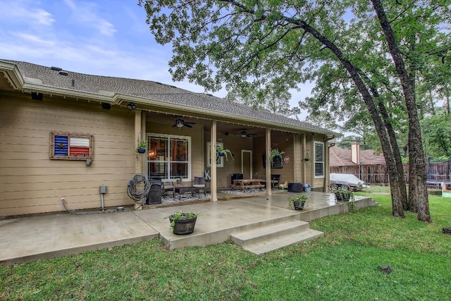 115 Loblolly Ln, Bastrop, TX 78602 - rear view of house with ceiling fan and a patio